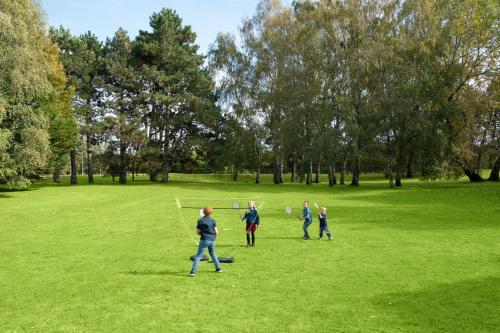a group of people playing frisbee in a field at Novotel Roissy Saint Witz in Saint-Witz
