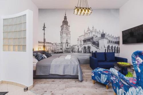 a bedroom with a king sized bed in front of a building at Zamenhofa Studio Kraków by Renters in Krakow