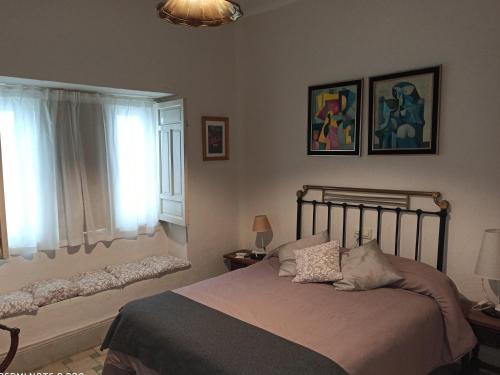 a bedroom with a bed and a window at La Casa De Las Bicicletas in Cazorla