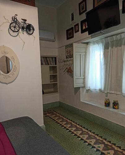 a room with a bike on the wall and a window at La Casa De Las Bicicletas in Cazorla