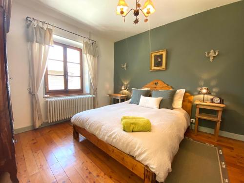 a bedroom with a bed with a yellow pillow on it at Les Ô d'Annecy in Saint-Jorioz