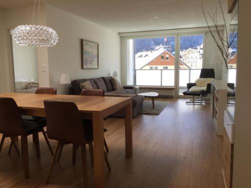 a living room with a table and a couch at Apartment Titliszentrum 2 by Interhome in Engelberg