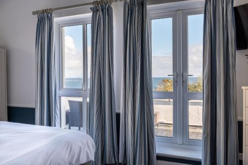 a bedroom with a bed and a large window at The White Lodge Hotel in Filey