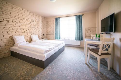 Postel nebo postele na pokoji v ubytování Penzion Papírna