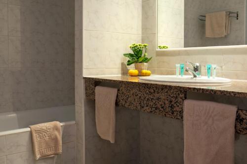 a bathroom with a sink and a mirror at Apartamentos Paya II in Es Pujols