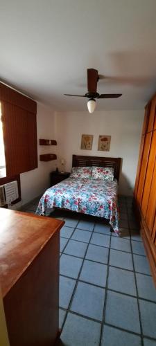 Schlafzimmer mit einem Bett und einem Deckenventilator in der Unterkunft Apartamento na Praia do Forte Cabo Frio in Cabo Frio