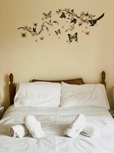 a bedroom with a bed with butterflies on the wall at Private Apartment in Dumfries