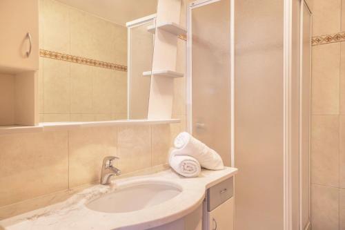 a bathroom with a sink and a shower at Haus Belodei - Apt B in San Martino in Badia