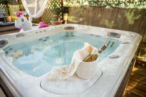 a hot tub with a bottle of champagne in it at La Stagione dell'Arte B&B in Stiava