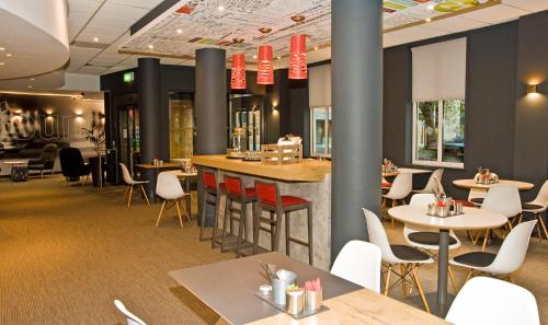 a restaurant with tables and chairs and a bar at Ibis Sheffield City in Sheffield