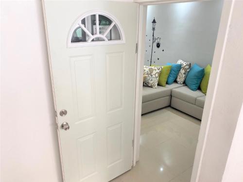 a white door leading into a living room with a couch at Casa nueva recien equipada y completa. in Chihuahua