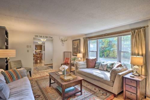 a living room with a couch and a table at Woodsy Diamond Point Getaway - 5 Mi to Lake George in Diamond Point