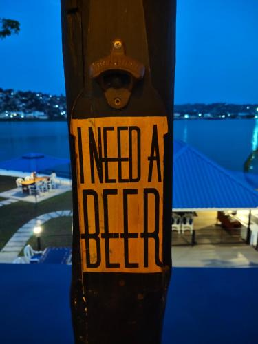 a sign on a pole that reads i need a died at Hotel Tilapia in Mwanza