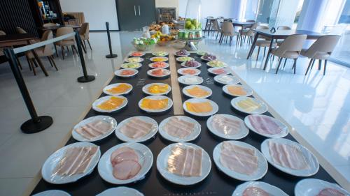 a long table with many plates of food on it at QH Praia de Quiaios in Praia de Quiaios
