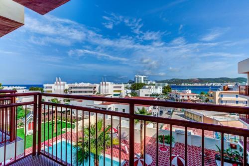 a balcony with a view of the ocean and buildings at Romeos Ibiza - Adults Only in San Antonio Bay