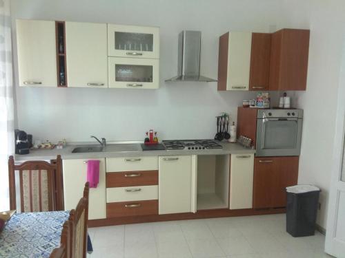 卡塔尼亞的住宿－PEDRA HOUSE，厨房配有木制橱柜和炉灶烤箱。