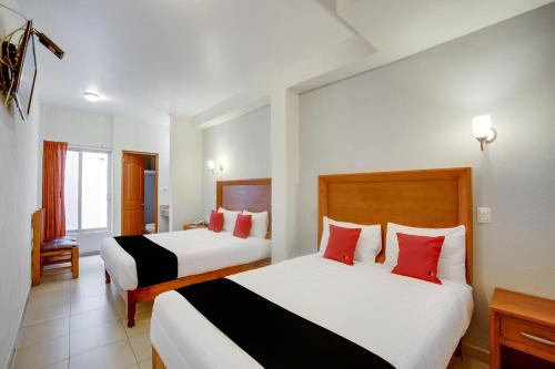 Postel nebo postele na pokoji v ubytování Hotel Patzcuaro