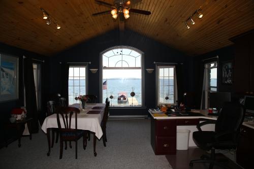 a dining room with a table and a large window at Home of Thousand Islands in Gananoque