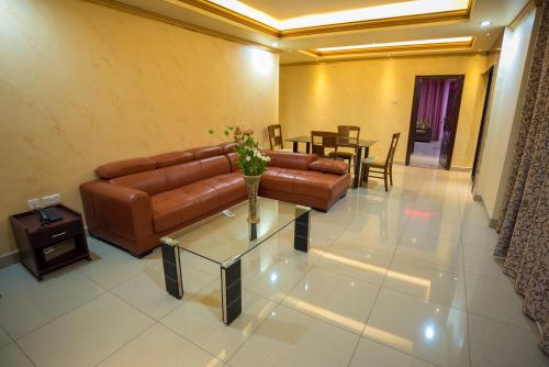 a living room with a couch and a table at Euro Hotel and Apartments in Dar es Salaam