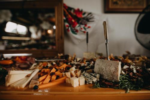 a pile of food on a wooden table at Pensiunea Curtea lui Toader in Simioneşti