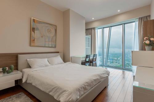 a bedroom with a bed and a desk and a large window at Moscow City Apartment Luxury Апартаменты Москва Сити 48-75 floors in Moscow