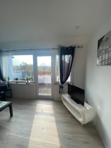 a living room with a flat screen tv on a wall at Modernes 2 Zimmer Appartment in Göttingen