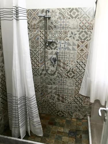 a shower with a shower curtain in a bathroom at Casa di Angela in Sciacca