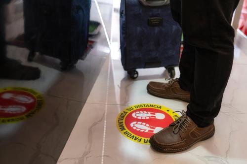a person standing next to a sign on the floor at Hotel El Rubi in Huaraz