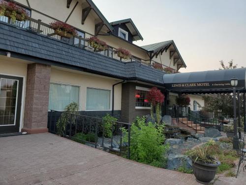 a building with a balcony with plants on it at Three Forks Lewis & Clark Motel in Three Forks