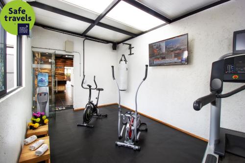 a room with a gym with a bike in it at Hotel MX roma in Mexico City