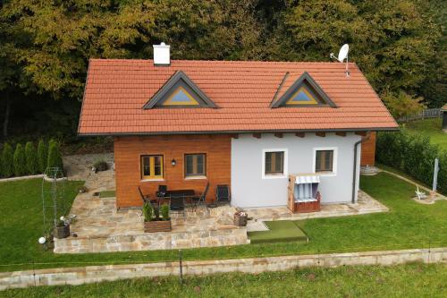 a small house with an orange roof at Panoramablick in Langegg an der Schilcherstraße