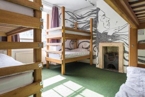 a room with bunk beds and a fireplace at The Full Moon Backpackers in Bristol