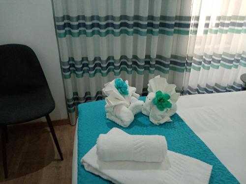 a room with towels and towels on a table at O Salgueiro in Melo