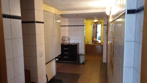 a hallway of a bathroom with a sink and a toilet at Zimmervermietung Koltermann in Greifswald
