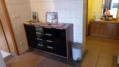 a bathroom with a counter with books on it at Zimmervermietung Koltermann in Greifswald