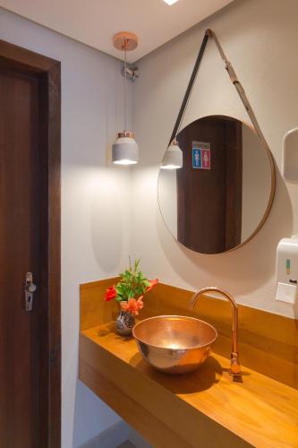 a bathroom with a bowl sink and a mirror at Pousada da Chácara in Mariana