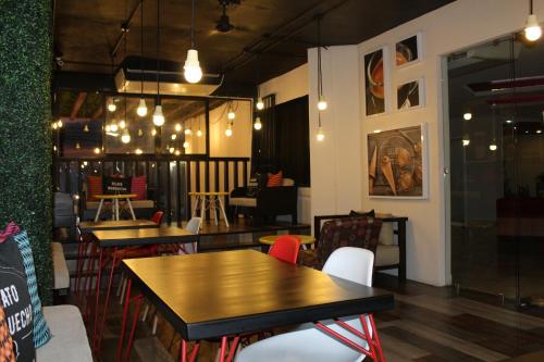 a dining room with tables and chairs and lights at Hotel Florencia Poza Rica in Poza Rica de Hidalgo