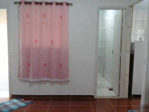 a bathroom with a pink curtain and a shower at Villa Maria DA Luz ROCHA Olimpia in Olímpia