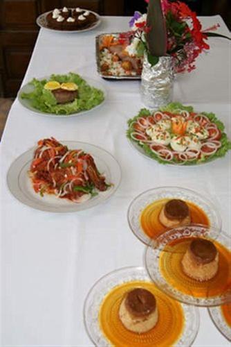 a white table with plates of food on it at Hotel Aurore Lomé in Lomé