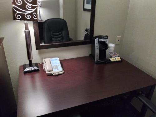 a desk in a hotel room with a phone on it at Holiday Inn Express Pittsburgh West - Greentree by IHG in Pittsburgh