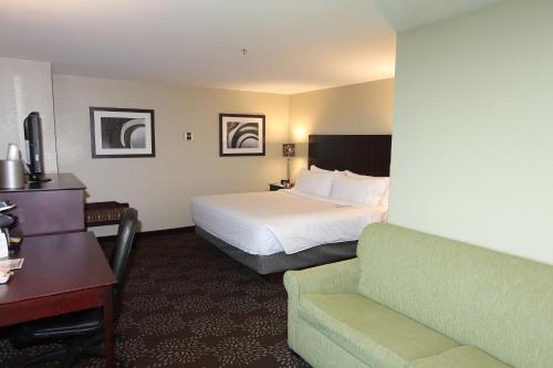 a hotel room with a bed and a couch at Holiday Inn Express Pittsburgh West - Greentree by IHG in Pittsburgh