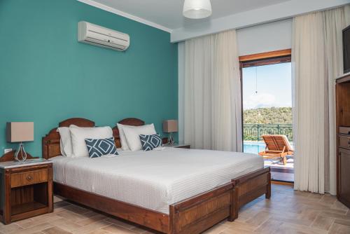 a bedroom with a bed and a balcony at Asteria Villas in Meganisi