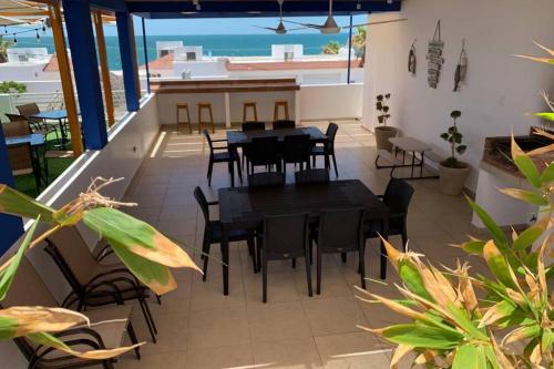 a patio with a table and chairs and the ocean at Diamante Joyas Del Mar Bahia de Kino in Bahía Kino