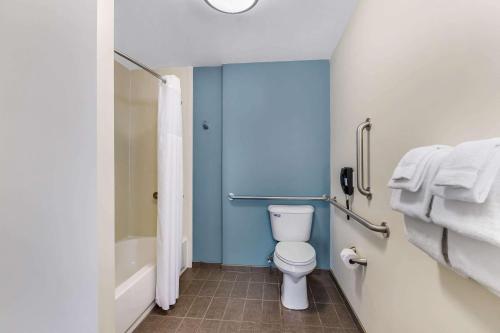 a bathroom with a toilet and a bath tub at Sleep Inn & Suites Ames near ISU Campus in Ames