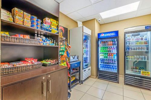 a grocery store aisle with a refrigerator and food at Sleep Inn & Suites Ames near ISU Campus in Ames