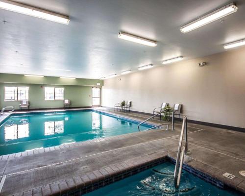 a large swimming pool with blue water in a building at Sleep Inn in Nampa