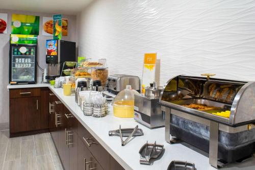 a restaurant kitchen with a counter with food at Quality Inn Plainfield - Indianapolis West in Plainfield