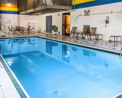 a large swimming pool with chairs and tables at Sleep Inn Midland in Midland