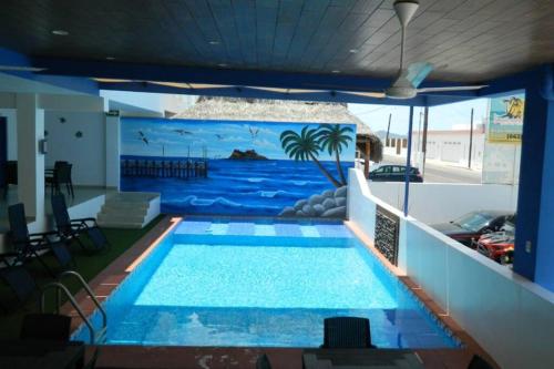 a large swimming pool with a mural of the ocean at Rubí Joyas del Mar Bahia de Kino in Bahía Kino
