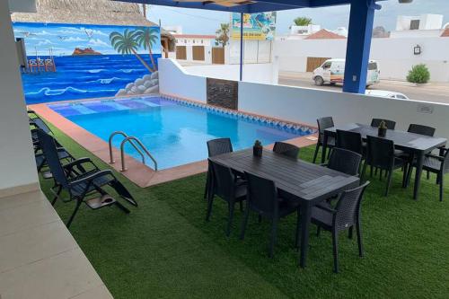 a rendering of a swimming pool with tables and chairs at Rubí Joyas del Mar Bahia de Kino in Bahía Kino